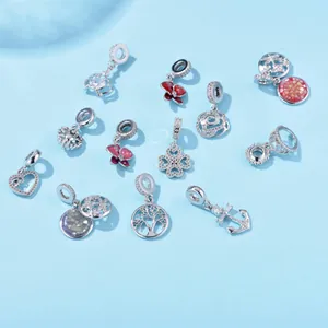 Detailed close-up of mixed silver charms with enamel and cubic zirconia for DIY bracelets