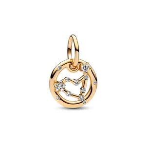 Macro detail of golden celestial zodiac charm with star pattern and sparkling crystals