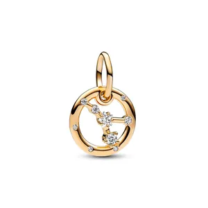 Macro shot of gold-plated constellation charm with sparkling star-shaped zirconia stones