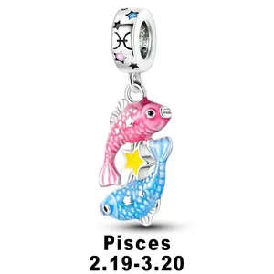 Macro detail of Pisces zodiac charm with silver fish, yellow star and blue enamel scales