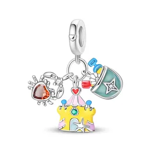 Detail of beach themed alloy charms with red crab, yellow castle and enamel bucket