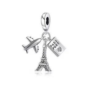 Silver travel charm featuring airplane, Eiffel Tower and passport with heart detail