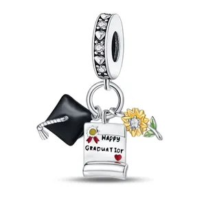 Detail of graduation charm with mortarboard, sunflower and Happy Graduation scroll