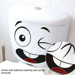 Detail view of funny winking face toilet sticker with adhesive backing on ceramic tank