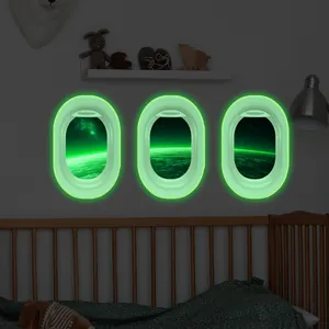 Glow in the dark airplane window wall decals featuring glowing space and Earth scenery