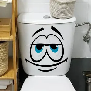 Funny cartoon smiling face toilet sticker applied to a white modern ceramic bathroom tank