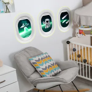 Glow-in-the-dark astronaut and UFO wall decals in airplane window frames for kids room