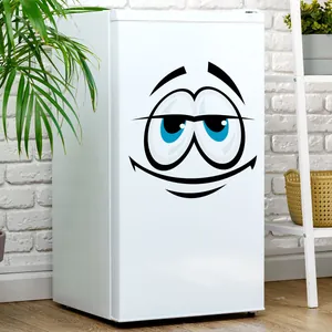 Macro shot of a cartoon smiling face wall sticker applied to a white mini fridge
