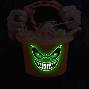 Secchiello per caramelle di Halloween arancione fluorescente con viso di mostro pauroso