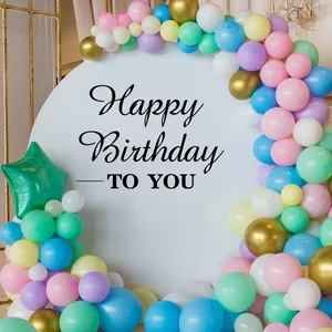 Detail of macaron balloon arch with metallic gold accents for birthday party decor