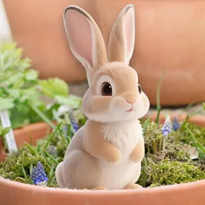 Close-up of a cute cartoon rabbit garden stake placed in a flower pot with moss