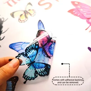 Detail of hand peeling colorful butterfly wall sticker with self-adhesive backing