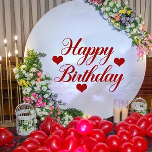 Close-up of white round Happy Birthday backdrop with red heart pattern and festive florals