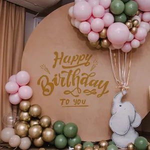 Detail of round beige Happy Birthday backdrop with balloon arch for party decor