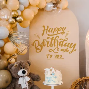 Arched party backdrop set with Happy Birthday lettering, balloons and a cute teddy bear