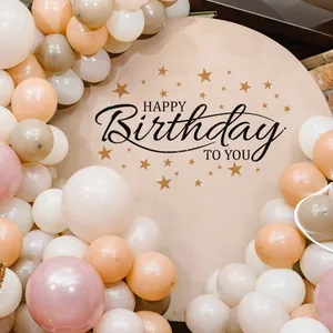 Detail of round Happy Birthday backdrop board with gold stars and festive balloon decor