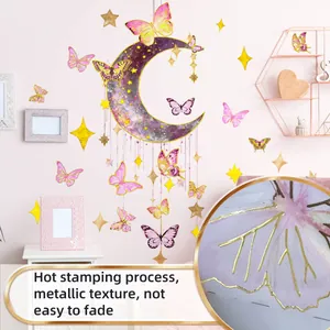 Detail of hot stamping moon and butterfly wall decals with golden metallic texture