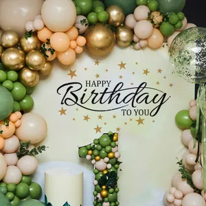 Detail of forest green and gold balloon arch with Happy Birthday backdrop and number 1 frame