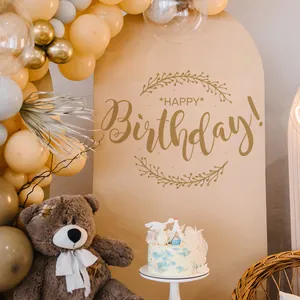 Detail of milk tea arched birthday backdrop with gold Happy Birthday lettering and balloons