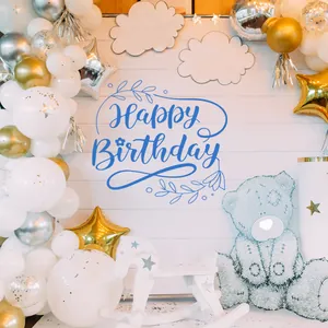 Detail of Happy Birthday backdrop with blue floral lettering and festive balloon arch