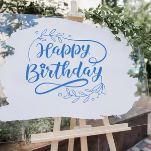 Detail of acrylic Happy Birthday sign with white brush strokes on a wooden easel