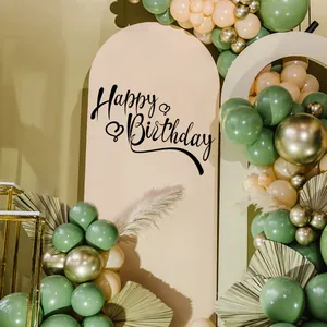 Detail of Happy Birthday backdrop with sage green balloons and dry palm leaves