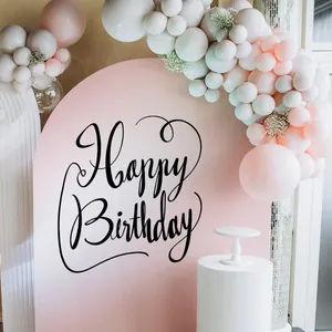 Detail of pink arch backdrop with Happy Birthday wall stickers and pastel balloon garland