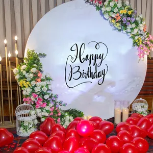 Detail of white round backdrop cover with black Happy Birthday text for party decor
