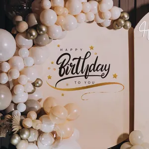 Detail view of champagne gold balloon garland with Happy Birthday printed backdrop