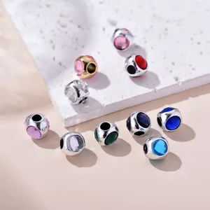 Macro detail of assorted multicolor crystal beads with silver and gold metal bases