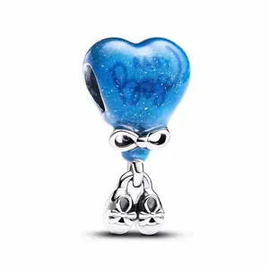 Blue heart charm bead with silver bow and ballet shoes pendants on white background