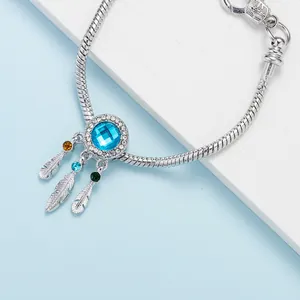 Silver dreamcatcher charm bracelet with blue square gemstone and colorful feather pendants