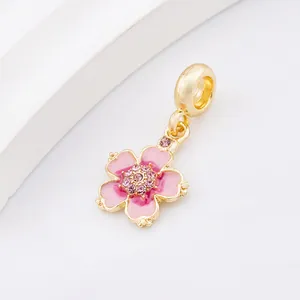 Pink enamel cherry blossom charm bead in gold finish with sparkling crystals