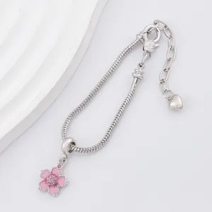 Silver snake chain bracelet with pink cherry blossom pendant and heart charm accent