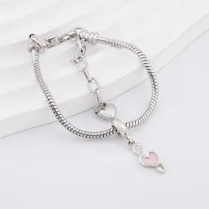 Silver snake chain bracelet featuring polished metal heart and pink enamel heart charms
