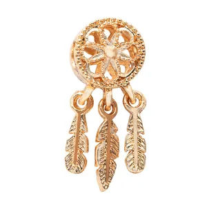 Detailed view of a golden dreamcatcher pendant featuring three delicate hanging feathers