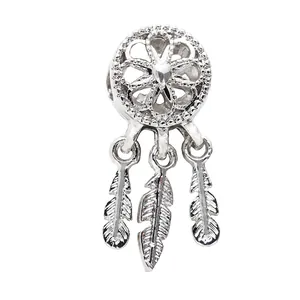 Silver dreamcatcher charm bead with heart center and three feather pendants on white background