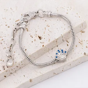 Silver snake chain bracelet featuring a seashell charm with blue and white crystals
