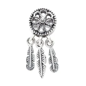 Macro detail of silver dreamcatcher charm with delicate hanging feathers for bracelets