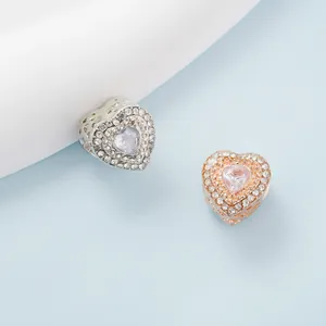 Elegant heart-shaped charm with double pavé crystals in silver and rose gold finish