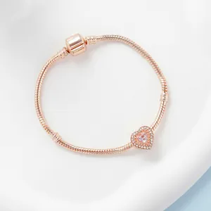 Elegant rose gold snake chain bracelet featuring a sparkling pink heart-shaped charm