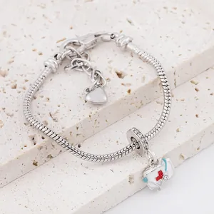 Silver snake chain bracelet featuring medical emergency kit and heart charms with zircons