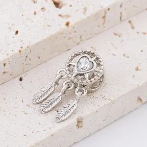 Silver dreamcatcher charm with heart-shaped zircon and three delicate feather pendants
