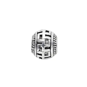 Macro shot of vintage hollow spacer bead with antique silver finish and engraved pattern