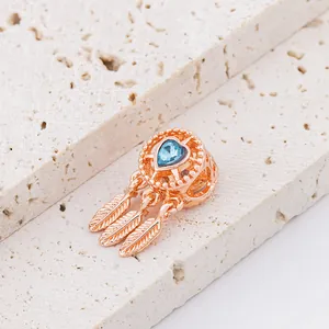 Rose gold dreamcatcher bead with heart blue gemstone and three feather pendants