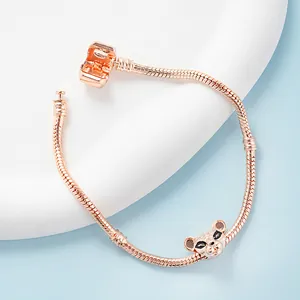Elegant rose gold snake chain bracelet with leopard head charm on a minimalist stone base