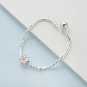 Silver snake chain bracelet with pink enamel charm and sparkling crystal accents
