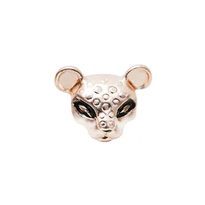 Detailed view of rose gold leopard head charm with black spotted enamel finish