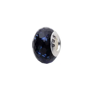 Macro view of faceted deep blue charm with glitter and 925 silver metal core