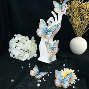 Artistic layout of blue and pink 3D butterfly wall stickers with golden edges on dark base